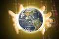 Close up person`s hands holding lighten planet earth, space concept. Elements of this image furnished by NASA Royalty Free Stock Photo