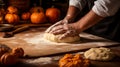 Close up of a person\'s hands rolling out pumpkin pie dough