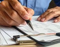Close-up of Person Signing Document with Pen on Desk Royalty Free Stock Photo