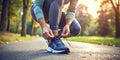 A close-up of a person tying running shoes, ready for a jog in a scenic park, showcasing the active and health-conscious side of