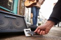 Close Up Of Person Using Contactless Payment Machine At Feet Of Female Musician Busking In Street Royalty Free Stock Photo