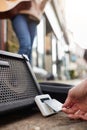 Close Up Of Person Using Contactless Payment Machine At Feet Of Female Musician Busking In Street