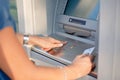 Close-up Of Person Using Credit Card To Withdrawing Money From ATM Machine Royalty Free Stock Photo