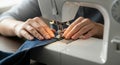 Close-up of a person using a sewing machine to create new clothes in a workshop Royalty Free Stock Photo