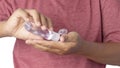 Close up of person using small portable antibacterial hand sanitizer on hands