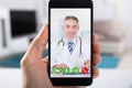 Person Video Conferencing With Doctor On Smartphone