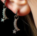 A close up of a person& x27;s ear with a pair of earrings. Generative AI image. Royalty Free Stock Photo
