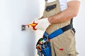 Close-up Of Person& x27;s Hand Installing Electrical Socket On Wall With Screwdriver Royalty Free Stock Photo