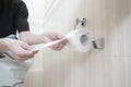 a close up person& x27;s hand taking a toilet paper Royalty Free Stock Photo