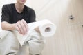 a close up person& x27;s hand taking a toilet paper Royalty Free Stock Photo