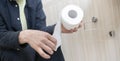 a close up person& x27;s hand taking a toilet paper Royalty Free Stock Photo