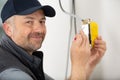 close-up persons hand installing socket on wall at home Royalty Free Stock Photo
