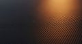 Close-up perspective of dark carbon fiber weave texture with warm orange light reflection Royalty Free Stock Photo