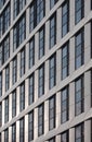 Perspective detail of tall high rise modern apartment building with geometric white cladding and dark windows Royalty Free Stock Photo