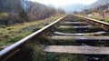 Close Up perspective view of railway tracks on a bright sunny day. Rails and wooden sleepers in oil with crushed stone. low down Royalty Free Stock Photo