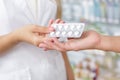 Close up of a pharmacist giving pills to the customer