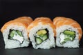 Close-up philadelphia roll sushi with salmon, cucumber, avocado, cream cheese. Sushi menu.Delicious traditional japanese food on Royalty Free Stock Photo