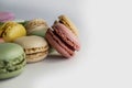 Close up phot of sweet macarons and spring tulip flowers on white background Royalty Free Stock Photo