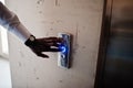 Close up photo of african american man hand with watches at elavator or modern lift, pushing button Royalty Free Stock Photo