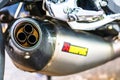 A close-up photo of Akrapovic exhaust muffler on custom motorcycle in Bucharest, Romania, 2019