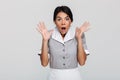 Close-up photo of amazed brunette maid in uniform standing with