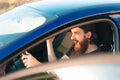 Close up photo of angry driver man with beard screaming while standing in traffic jam Royalty Free Stock Photo