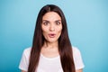 Close up photo of attractive cute interested girl astonished with something odd while isolated with blue background