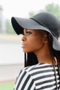 Close up photo of attractive pretty american girl. Female looking at somewhere. Model in black hat.