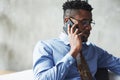Close up photo of attractive stylish black businessman in suit talking phone having deal
