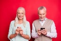 Close up photo beautiful she her he him his aged white hair guy lady partners hold hands arms telephones texting