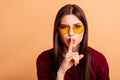 Close up photo beautiful she her lady ask stop tell say speak news listen sound index finger near mouth wear sun specs Royalty Free Stock Photo