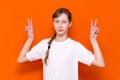 Closeup photo of beautiful little braided hair girl arms showing v-sign symbol hi friends good mood wear white t-shirt