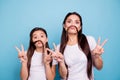 Close up photo beautiful two people brown haired mom small little daughter make funky moustache curls like guys man male