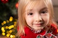 Close up photo of a blonde little girl with beautiful brown eyes joyful looking at the camera over the lights on the Royalty Free Stock Photo