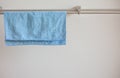 Close-up photo of a blue microfiber cloth for cleaning on the drying rack. Cloth for cleaning. Royalty Free Stock Photo