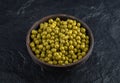 Close up photo of Bowl full with Green marinated olives on black background Royalty Free Stock Photo