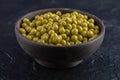 Close up photo of Bowl full with Green marinated olives on black background Royalty Free Stock Photo