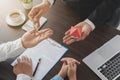 Close up photo of broker giving keys of new house  After the banker has approved and signed the purchase agreement successfully. Royalty Free Stock Photo