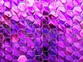 A close-up photo of a buildings facade featuring an intricate pattern of hexagonal tiles in a vibrant purple hue