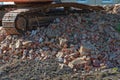 Bulldozer chain on a heap of old bricks