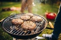 Close-up photo of burger cutlets on grill. Tasty food cooking. Friends picnic on warm summer day Royalty Free Stock Photo