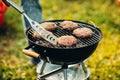 Close-up photo of burger cutlets on grill. Tasty food cooking. Friends picnic on warm summer day Royalty Free Stock Photo