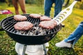 Close-up photo of burger cutlets on grill. Tasty food cooking. Friends picnic on warm summer day Royalty Free Stock Photo