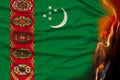 Close-up photo of the burning national flag of the state of Turkmenistan, concept of state crisis, destruction, illustration Royalty Free Stock Photo