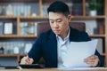 Close-up photo of businessman in office working on paper, serious and focused asian boss signing documents Royalty Free Stock Photo