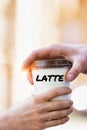 Close up photo of businesswoman giving businessman a cup of coffee latte Royalty Free Stock Photo