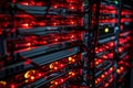 This close-up photo captures a rack of servers prominently displaying red and black components, A dramatic view of the inside of a Royalty Free Stock Photo