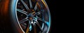 Close-up photo of a car wheel in the black background studio