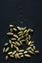 Close up photo of Cardamom pods and seeds pile on the matt black background. It is very popular in Indian and Sri Lanka cuisine Royalty Free Stock Photo