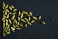 Close up photo of Cardamom pods and seeds pile on the matt black background. It is very popular in Indian and Sri Lanka cuisine Royalty Free Stock Photo